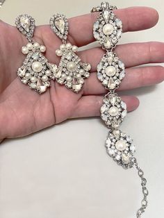 Hollywood Glam crystal earrings, made with top Swarovski rhinestones hand sett on silver filigree drop . finished with hypo allergenic surgical steal ear wire.  Original design , hand crafted by me in my studio. Light weigh and very comfortable to wear .  Matching necklace at this link: https://www.etsy.com/listing/1069151729/bridal-crystal-necklace-vintage-style?ref=shop_home_active_1&frs=1 Please contact me if you have any questions. Vintage Bridal Earrings, Wedding December, Opal Wedding, Earrings Chandelier, Studio Light, Earrings Large, Hollywood Glam, Wedding Jewelry Earrings, Earrings White