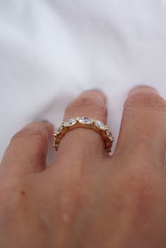 a person's hand with a gold ring on their left and diamond band on the right