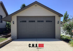 oversized garage door in bronze with second section arched windows Oversized Garage, Residential Garage Doors, Overhead Garage, Residential Garage, Door Colors, Garage Door Design