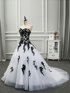 a black and white ball gown with flowers on it