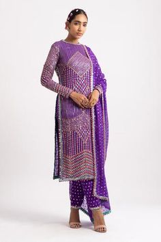 Purple straight kurta with multicolored hand embroidery in geometric pattern. Paired with fully embroidered pant and dupatta with mirror border.
Component: 3
Pattern: Embroidered
Type Of Work: Mirror
Neckline: Round
Sleeve Type: Straight Full
Fabric: Georgette; Lining: Silk Blend
Color: Purple
Other Details: 
Side high slit kurta
Cutwork hem
Note: The other kurta set worn by the other model is not for sale
Occasion: Destination Wedding - Aza Fashions Vani Vats, Maharani Designer Boutique, Mirror Border, Blouse Yoke, A Line Kurta, Embroidered Pants, Designer Boutique, Kurta With Pants, Purple Silk