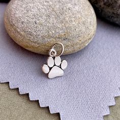 Darling Tiny Sterling Silver Paw Print Charm Dimensions: H: 1mm L: 13mm W: 9mm Length measurement includes the 5 mm soldered jump ring. Need a Chain? Cable: https://www.etsy.com/listing/882796685/14kt-gold-filled-or-925-sterling-silver? Box: https://www.etsy.com/listing/746309155/4kt-gold-filled-or-925-sterling-silver? Find more charms in my supply shop: ImprintedMemoriesToo.etsy.com Find complete ready to gift personalized jewelry in my main shop: ImprintedMemories.etsy.com Due to the small siz Minimalist Charms With Lobster Clasp, Silver Minimalist Charms With Lobster Clasp, Minimalist Silver Charms For Jewelry Making, Minimalist Sterling Silver Dangle Charms, Silver Sterling Jewelry For Best Friend Gift, Silver Dog Tag Jewelry With Charms, Silver Hypoallergenic Dog Tag Jewelry, Hypoallergenic Sterling Silver Dog Tag Jewelry, Hypoallergenic Silver Dog Tag Jewelry