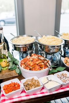 a buffet table filled with lots of different foods and condiments on top of it