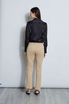 Nothing beats the chic factor and luxe patina of a Silk Satin shirt. Our button-down design features a v-neckline that is perfect for layering under a blazer or wearing on its own- you will live in this shirt all season long. Elie Tahari Exclusive Long Sleeve Silk Satin Button Down shirt 100% Silk Relaxed Fit; Runs true to size. Model is 5'9" and wearing size S Length From Shoulder to Hem: Back 26"L, Sleeve 32.5"L (approx. length for size S) Dry Clean Only Imported Style #: E107G513 Chic Semi-formal Blouse With Hidden Button Closure, Elegant Tailored V-neck Top, Elegant V-neck Top With Button Cuffs, Elegant Slim Fit Blouse For Work, Elegant Notch Lapel Tops For Spring, Elegant Spring Tops With Notch Lapel, Luxury Lapel Collar Top For Workwear, Elegant Business Blouse For Fall, Chic Lapel Collar Tops For Office