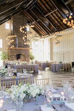 the tables are set up for a formal function in front of an open fire place