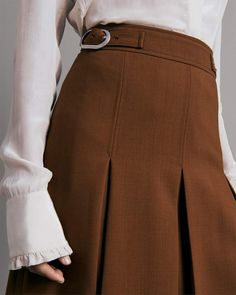 Crafted from a wool and cotton blend, this classic fit, vintage-inspired skirt is high waisted and features inverted box pleats. rag & bone Women's Wool Skirt | Camel Brown, 8 (also in 6).