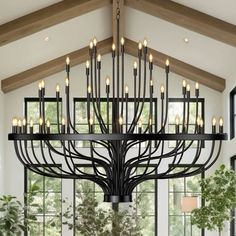 a large chandelier hanging from the ceiling in a room with lots of windows