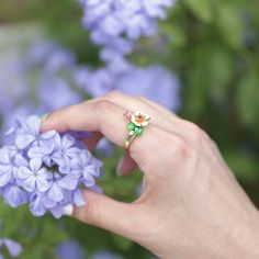 Pear blossoms traditionally represent purity, love, and longevity in Chinese culture and are also considered one of the most beautiful flowers when they are kissed with raindrops, sometimes used to describe attractive women, further promoting the flower's feminine nature. The ring features pear blossoms and leaves that wrap around your finger, detailed with bright enamel for lovers of colour! The perfect accessory for spring and summertime, or to keep the floral vibe going all year round.Carat W Delicate Flower Shaped Ring For Spring, Delicate Spring Jewelry For Anniversary, Delicate Jewelry For Spring Anniversary, Delicate Jewelry For Anniversary In Spring, Floral Jewelry For Spring Weddings, Spring Wedding Flower Ring, Delicate Flower Ring For Spring, Spring Rose Gold Flower Ring, Spring Flower Jewelry For Anniversary