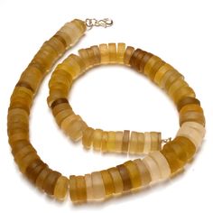 the necklace is made out of yellow and brown glass beaded with silver clasps