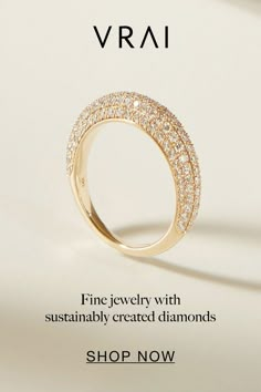 a gold ring with diamonds on it and the words vrai written in white lettering