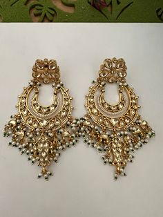 This intricately handmade pair with pearl drops is perfect for any traditional look.  You will definitely fall in love with these sabyasachi kundan earrings. Light weight and comfortable. One of our favourite picks for the wedding season . Be bold, be stylish, and be your best always. The weight of the earrings is 44 g. The length of the earrings is 9 cm. The width of earrings is 5 cm. Luxury Kundan Bridal Earrings For Diwali, Luxury Kundan Pearl Earrings, Luxury Chandbalis With Stone Work For Reception, Festive Temple Jewelry Pearl Earrings With Stone Work, Temple Style Chandbalis With Stone Work For Reception, Temple Jewelry Style Danglers With Stone Work For Reception, Reception Temple Jewelry Danglers With Stone Work, Traditional Chandbalis With Stone Work For Reception, Traditional Stone Work Chandbalis For Reception