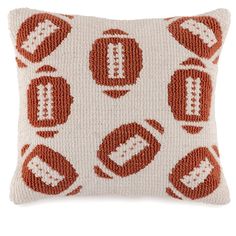 an orange and white knitted pillow with circles in the middle, on a white background