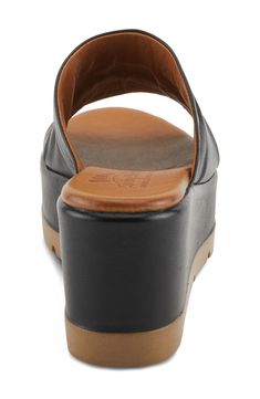 Delicate ruching along the vamp lends textural intrigue to a leather slide sandal lofted by a chunky platform and integrated wedge heel. 3" heel; 1 1/2" platform Leather upper and lining/synthetic sole Made in Turkey Black Leather Wedge Heel Platform Slippers, Chic Leather Platform Slide Slippers, Leather Slide Mules With Padded Heel, Modern Leather Footbed Slide Wedge Sandals, Leather Slide Wedge Sandals, Leather Slide Sandals With Padded Heel, Modern Slides With Leather Footbed And Wedge Heel, Modern Leather Footbed Slides With Wedge Heel, Synthetic Clogs With Leather Footbed And Wedge Heel