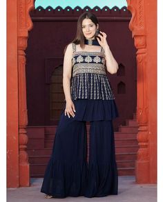 For a pretty look, Add this readymade peplum sharara dress to your wardrobe. This readymade peplum sharara dress is fabricated on faux georgette and beautified with embroidery work. It comes with a faux georgette bottom and dupatta. Available sizes are L(40"), XL(42"), XXL(44") New Style Suits, Buy Salwar Kameez Online, Indian Lehenga Choli, Pakistani Suit, Georgette Dupatta, Sharara Suit, Indian Gowns Dresses, Indian Lehenga