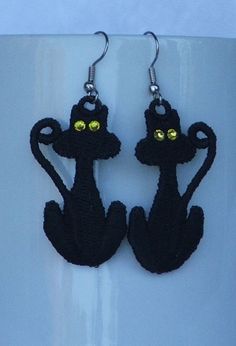 These cute kitties are perfect for the Halloween season (although they would be fun any time of year!) These black cat earrings have a Swarovski crystal in the eyes for extra sparkle!  They are designed by Sonia Showalter, and stitched by Deborah in PA, USA. These earrings are great for both children and adults, and are light and airy.  They are made of surgical steel earwires, so no worries about allergies! 100% handmade by Deborah in the USA Black Cat Ears Earrings For Party, Cute Cat Design Earrings For Party, Cute Black Dangle Jewelry, Black Cat Ears Earrings For Halloween, Black Cat Design Earrings For Halloween, Black Cat Design Drop Earrings, Black Halloween Jewelry With Cat Ears, Cute Black Cat Design Earrings, Cute Black Party Earrings