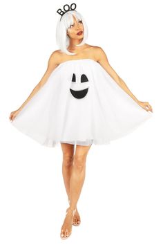 a woman in a white dress with a smiley face on it