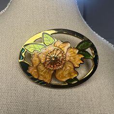 Gorgeous Vintage Enamel Flower Pin Brooch Brooch features a Lotus Flower in cloisonne style Gold with orange enamel flowers surrounded by enamel green leaves. Details: * Measures  approximately 2" H x 1.5" wide (at its widest point) * Gold tone metal finish * Secure roll-over clasp closure  * Brooch is unsigned  * Excellent condition, ready to wear Perfect for: Cloisonne brooch collectors  Lotus flower enthusiasts Vintage jewelry lovers Lovers of timeless jewelry Please reach out if you have any Collectible Gold Flower Enamel Pin, Green Flower-shaped Enamel Brooch Pin, Green Flower Shaped Enamel Pin Brooch, Green Flower Enamel Pin Brooch, Floral Enamel Brooch Pin, Flower Shaped Enamel Brooch Pin, Enamel Flower Brooch Pin, Flower Shaped Enamel Brooch, Flower Shaped Enamel Pin