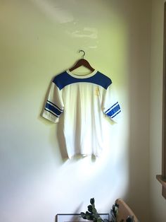 Up for sale is a vintage 1960's to 1970's Dodgers Sportswear "Lakers" athletic style shirt with beautiful graphics on the front and sleeves. Overall the garment is in good condition with no major rips or tears. There are some various faded spots of discoloration though no egregious stains exist (see photos for noted flaws). Dodger Sportswear 50% cotton 50% polyester Tag size: M Estimated size: S to M Measured flat (inches across): Length (back bottom of collar to bottom hem): 23 1/2 Pit to pit: Affordable Vintage T-shirts For Sports Season, Womens Vintage Workout Shirt, Retro College T-shirt With Screen Print, Collegiate Crew Neck Top With Three Stripes, College Cotton T-shirt With Three Stripes, Retro Screen Print T-shirt For College, Three Stripes Crew Neck T-shirt For College, Cotton Sports Tops With Three Stripes, Retro Crew Neck Shirt For College