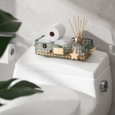 a bathroom with a white toilet and green plants