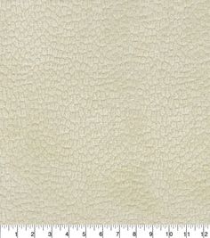 a white leather textured upholster with a ruler in front of the image