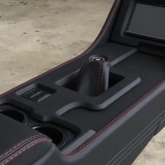 the interior of a black suitcase with red stitching