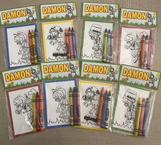 six coloring books with crayons in them