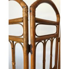 two pieces of furniture that are made out of wood and wickers, one is bent over the other side