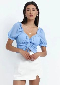 The Emes Shop top is detailed with a sweetheart neckline. and short puffed elasticized sleeves. Features center bust ruching and drawstring tie. This feminine and chic top is perfect for a warm summer day out. Finish off the look with a white mini skirt and heeled sandals.MATERIAL:100% Soft PolyMEASUREMENTS:Small : 4-6 Waist: 25-26.5 in Chest: 33-34.5 in Hips: 35-36.5 in Length: 10.6" in Medium : 6-8 Waist: 26.5-28 in Chest: 34.5-36 in Hips: 36.5-38 in Length: 10.7" in Large : 8-10 Waist: 28-... Ruched Crop Top, Puff Sleeve Shirt, White Mini Skirt, Trendy Blouses, Chic Top, Professional Women, Summer Day, Heeled Sandals, Shop Top