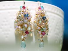 "THE JEWELRY IS SHIPPED via DHL EXPRESS (2-5 days delivery door to door). THE DHL SHIPPING COST IS INCLUDED IN THE PRICE. The Appassionata Earrings - Ethiopian Opal Long Cluster Earrings, Statement Earrings with Paraiba Tourmaline, Pink Tourmaline and Aquamarine ► Measurements / Details: - Length including earwire: 2.32\" (~5.9 cm) *can be made shorter per request - Gold: High quality Gold Filled - Silver: High quality Sterling Silver ► Gemstones: The earrings include excellent AAA quality gemst Fusion Style Party Earrings With Gemstone Accents, Fusion Multi-stone Earrings For Party, Multi-stone Dangle Earrings For Party, Multicolor Gemstone Accented Earrings For Wedding, Fine Jewelry Earrings With Gemstone Accents For Party, Multicolor Gemstone Accent Earrings For Wedding, Fine Jewelry Party Earrings With Gemstone Accents, Handmade Briolette Earrings For Party, Briolette Earrings With Gemstone Accents For Wedding