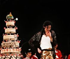 a man standing in front of a large cake