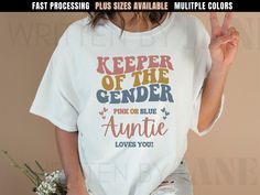 a woman wearing a t - shirt that says, keeper of the genderer pink or blue annie loves you