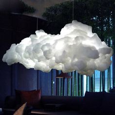 a cloud lamp hanging from the ceiling in a living room