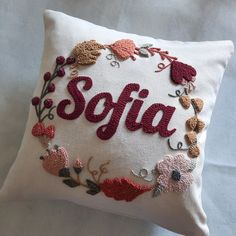 a white pillow with the word sofia embroidered on it