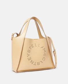 Women Cornflake Stella Logo Crossbody Bag | Stella McCartney US Stella Logo, Crossbody Tote Bag, Fall Holidays, Crossbody Tote, Goods And Services, Leather Material, Stella Mccartney, Crossbody Bag, Shoulder Strap