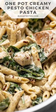 a pan filled with pasta and spinach covered in sauce