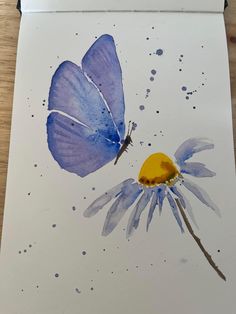 a blue butterfly sitting on top of a purple flower next to a yellow dandelion