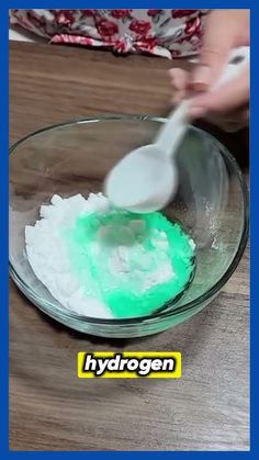 someone is mixing green and white powder in a bowl