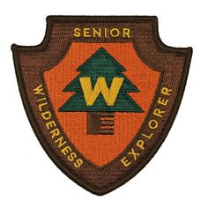 a patch with the words, wild wilderness explorer on it and an image of a tree