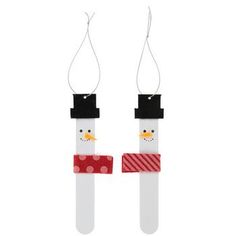 two snowmen made out of plastic tubes with red and white polka dots on them