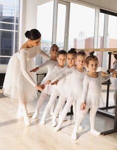 a group of young ballerinas standing next to each other