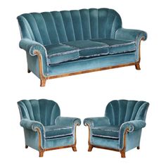 two blue velvet couches with wooden legs