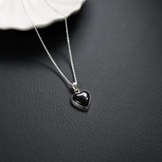 Elevate your jewelry collection with the timeless elegance of our 15mm Onyx Heart Pendant. Expertly crafted from premium 925 sterling silver, this exquisite pendant features a stunning onyx gemstone, intricately cut into a beautiful heart shape. The perfect blend of sophistication and charm, this pendant is a wonderful symbol of love and style. * Material: High-quality 925 sterling silver, renowned for its durability and lustrous finish. * Gemstone: Genuine Black onyx, providing a striking and e Black Heart Pendant Jewelry For Formal Occasions, Black Heart-shaped Gemstone Jewelry, Black Sterling Silver Heart Necklace For Anniversary, Silver Heart-shaped Jewelry With Black Enamel, Black Heart-shaped Sterling Silver Necklace, Black Sterling Silver Jewelry With Heart Charm, Black Jewelry With Heart Charm Pendant, Black Jewelry With Heart Charm, Black Sterling Silver Jewelry For Valentine's Day