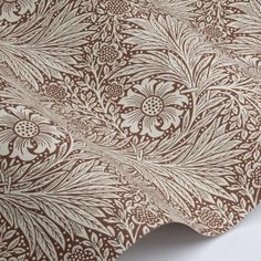 a brown and white wallpaper with an intricate design on the back side of it