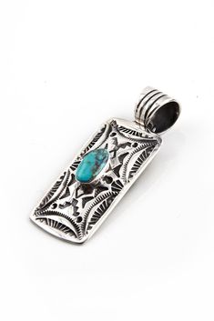 This Turquoise Pendant was handmade by Navajo artist, G. Ramone. The beautiful blue turquoise stone features the highly sought after reddish gold matrix. The oval stone is set upon a hand-stamped rectangular piece of sterling silver. The stamps are oxidized for a vintage look and include several Navajo symbols. The bail is perfect for a chain or beads. Hallmarked G. Ramone and Stamped Sterling Silver Southwestern Style Blue Turquoise Oval Pendant Necklace, Turquoise Sterling Silver Rectangular Pendant Necklace, Turquoise Rectangular Pendant Jewelry Gift, Navajo Symbols, Southwestern Blue Oval Pendant Jewelry, Western-style Sterling Silver Turquoise Pendant Necklace, Zuni Jewelry, Southwest Jewelry, Stone Feature