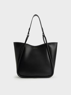 Elegance with a wear-anywhere appeal, this oversized tote bag is a must-have for any style-conscious minimalist. A sleek all-black finish is easy to incorporate into your wardrobe, while the roomy interior makes for ample storage space. If you need more, it also comes with a detachable inner pouch. Oozing versatile understated charm, this trans-seasonal tote bag will look brilliant with a patterned shift dress and flats for an effortless look. Charles And Keith Bags, Slouchy Tote Bag, Charles And Keith, Slouchy Tote, Slouchy Bag, Black Strappy Sandals, Oversized Tote Bag, Latest Bags, Oversized Tote