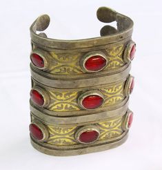 "Vintage Turkmen Traditional Ethnic Tribal Partial Gold Gilded Glass Beads Large Bracelet. Please do not hesitate to contact if you have any questions. Weight : 160.0 grams Inner circumference : 14.5 cm ( 5.7\" ) Width : 8.4cm ( 3.3\" ) Please know what you are bidding on. The metal of Most Kuchi, Afghan and Turkoman items are called with different names but they all work in same metal, Some called Alpaca silver, German Silver and Tibetan Silver. They do not give any allergies or body reaction . Traditional Red Bracelets For Festivals, Red Traditional Bracelets For Festival, Artisan Cuff Bracelet As Festival Gift, Artisan Adjustable Bangle For Festivals, Artisan Bangle Cuff Bracelet For Festivals, Bohemian Cuff Jewelry, Unique Adjustable Bangle For Ceremonial Occasions, Adjustable Unique Bangle For Ceremonial Occasion, Red Vintage Bracelets For Festivals