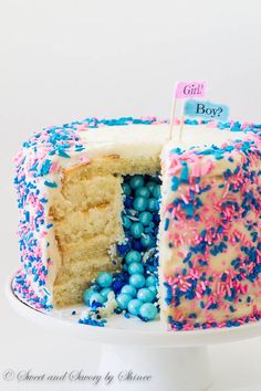 a white cake with blue and pink sprinkles