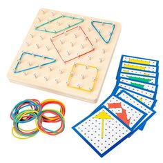 a wooden board with several different colored pieces and wires on top of it, including an arrow