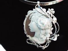 "This is a beautiful modern master hand carved sardonyx cameo by the artist, Carla. This is a very complex and intriguing piece and the design makes it an absolutely amazing piece of work. All the detail is exceptionally done to perfection! The right cameo is cameo is 48 mm mm (1.89\") and it is set into Italian silver with a 6 mm enhancer bail and a pin attachment. It comes packed in a black velvet box and certificate of authenticity for gift giving. Welcome to CASCO Cameos, LLC. CASCO Cameos i Luxury Cameo Pendant Jewelry, Luxury Cameo Medallion Jewelry, Luxury Intaglio Pendant Jewelry, Cameo Pendant For Jewelry Making, Elegant Carved Oval Jewelry, Elegant Oval Carved Jewelry, Luxury White Gold Cameo Jewelry, Exquisite Cameo Jewelry For Gift, Collectible White Cameo Jewelry