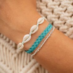 CORON BEACH BRACELET SET  Embrace the beauty of the ocean with our Coron Beach Bracelet Set. Crafted with ocean tones, this set will bring a touch of the sea to your everyday look. The perfect set of 3 bracelets for any beach lover! - Made with natural cowrie shells, a dainty silver chain, soft nylon cord and our durable wax polyester cord. - Bracelets measure approx. 17cm with a 7cm sliding knot extension on each side. - Handmade in Bali. - Biodegradable or recycled packaging. OTHER INFORMATION Beach Friendship Bracelets With Sliding Knot, Ocean-inspired Strand Friendship Bracelets As Gifts, Ocean-inspired Strand Friendship Bracelets As Gift, Turquoise Jewelry With Sliding Knot For Vacation, Turquoise Friendship Bracelets For Beach Season, Turquoise Bracelets With Sliding Knot For Vacation, Turquoise Sliding Knot Bracelet For Vacation, Adjustable Ocean Color Bracelets For Beach, Handmade Strand Braided Bracelets For Beach